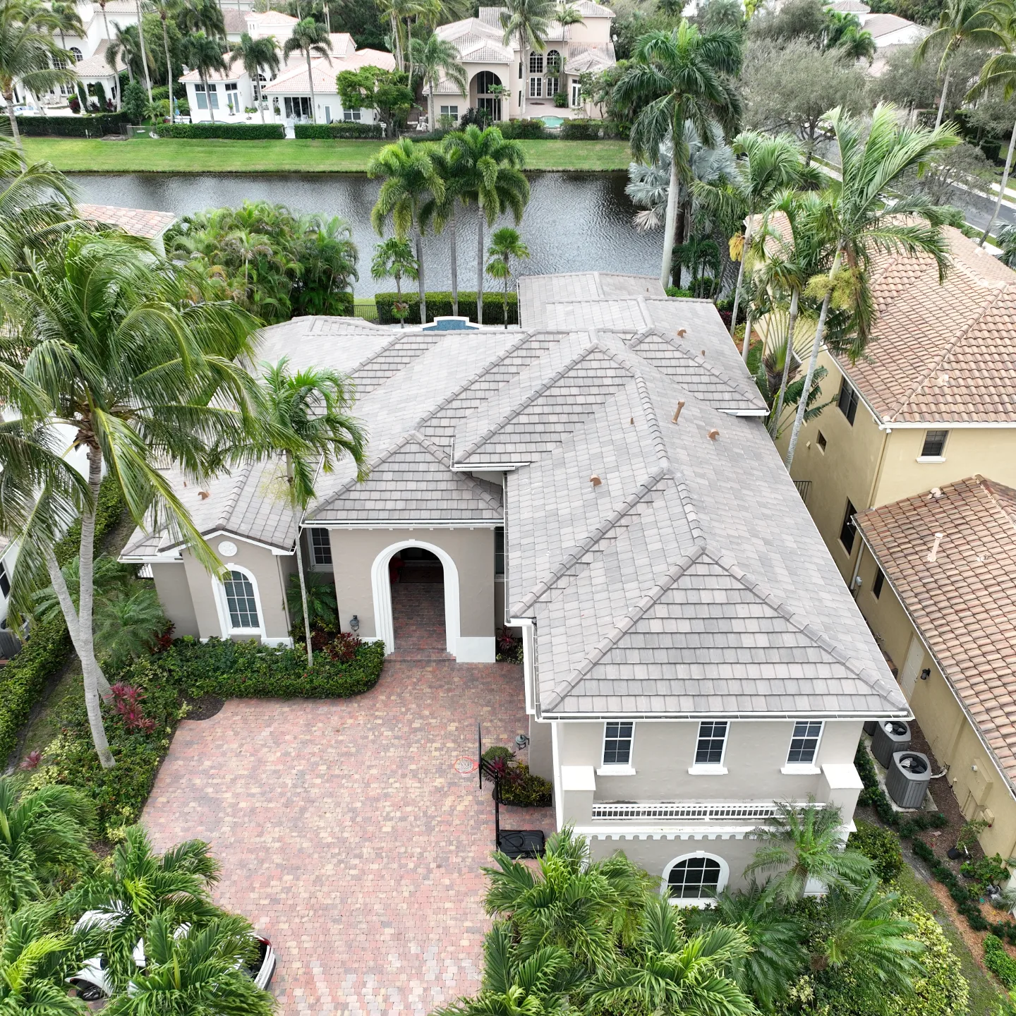 Professional concrete tile roof replacement by BLU Roofing on a waterfront residential estate in Palm Beach County.