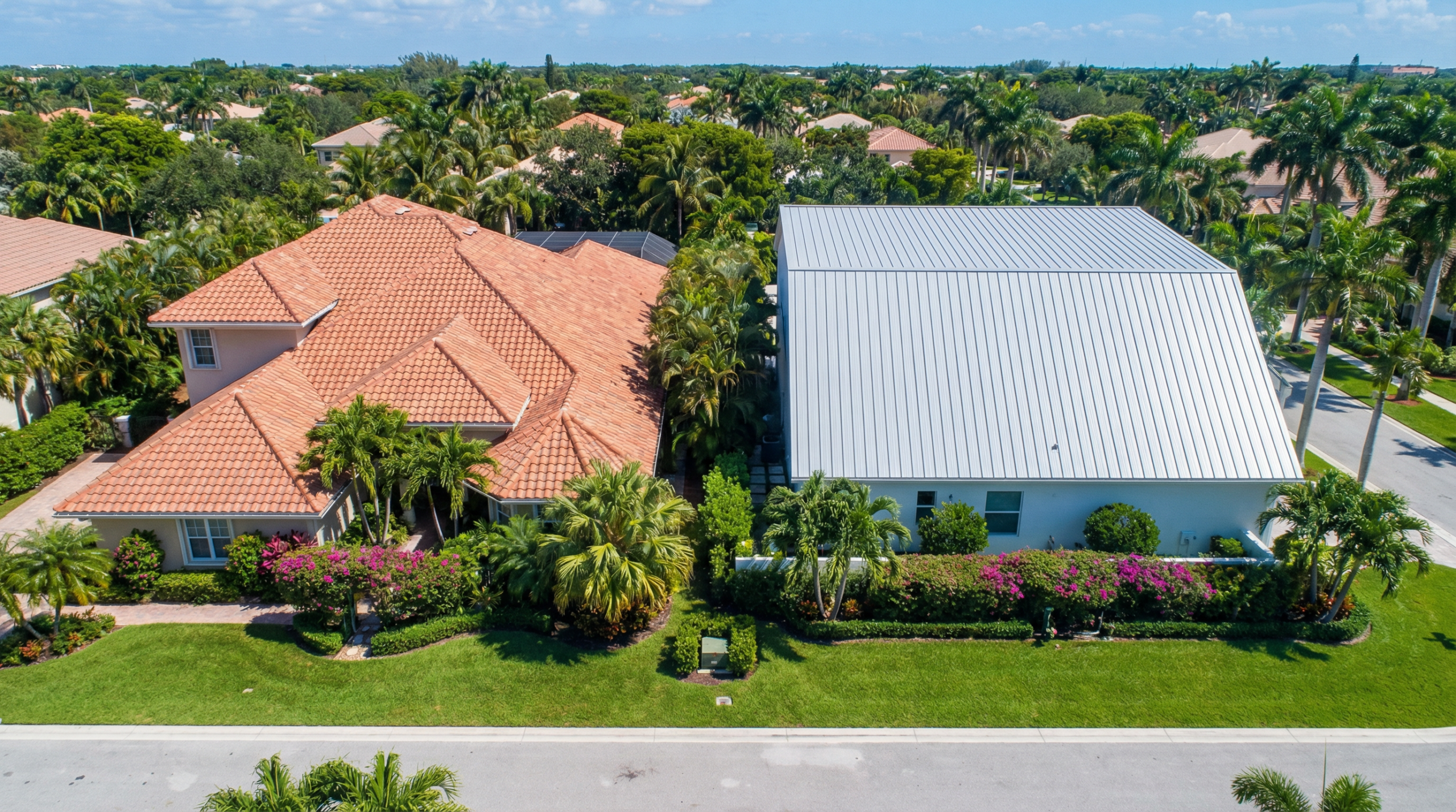 Side-by-side comparison of a terracotta tile roof and a standing seam metal roof on two South Florida homes