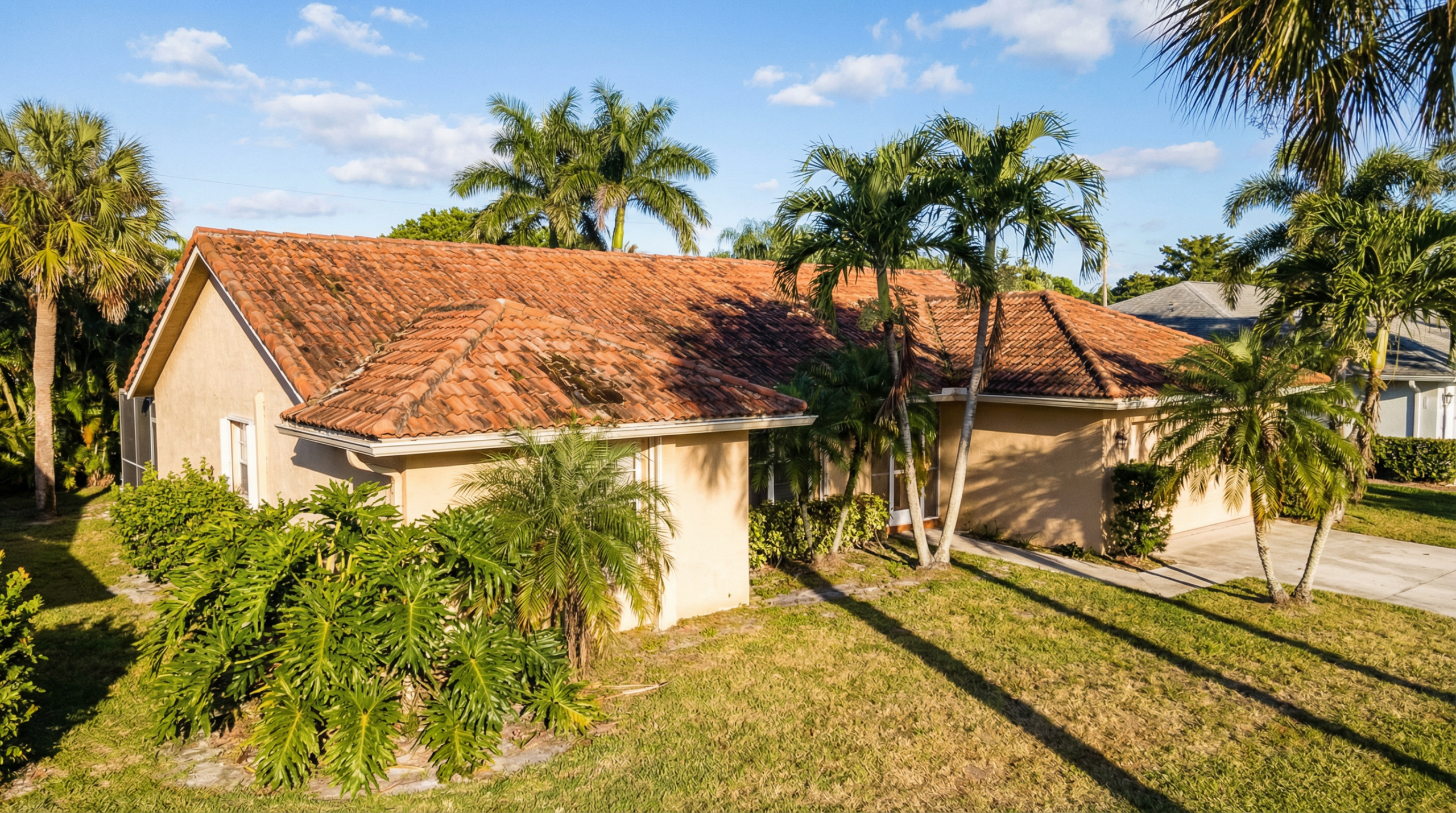 Aged tile roof on a Palm Beach Gardens Florida home showing the effects of South Florida climate on roof lifespan