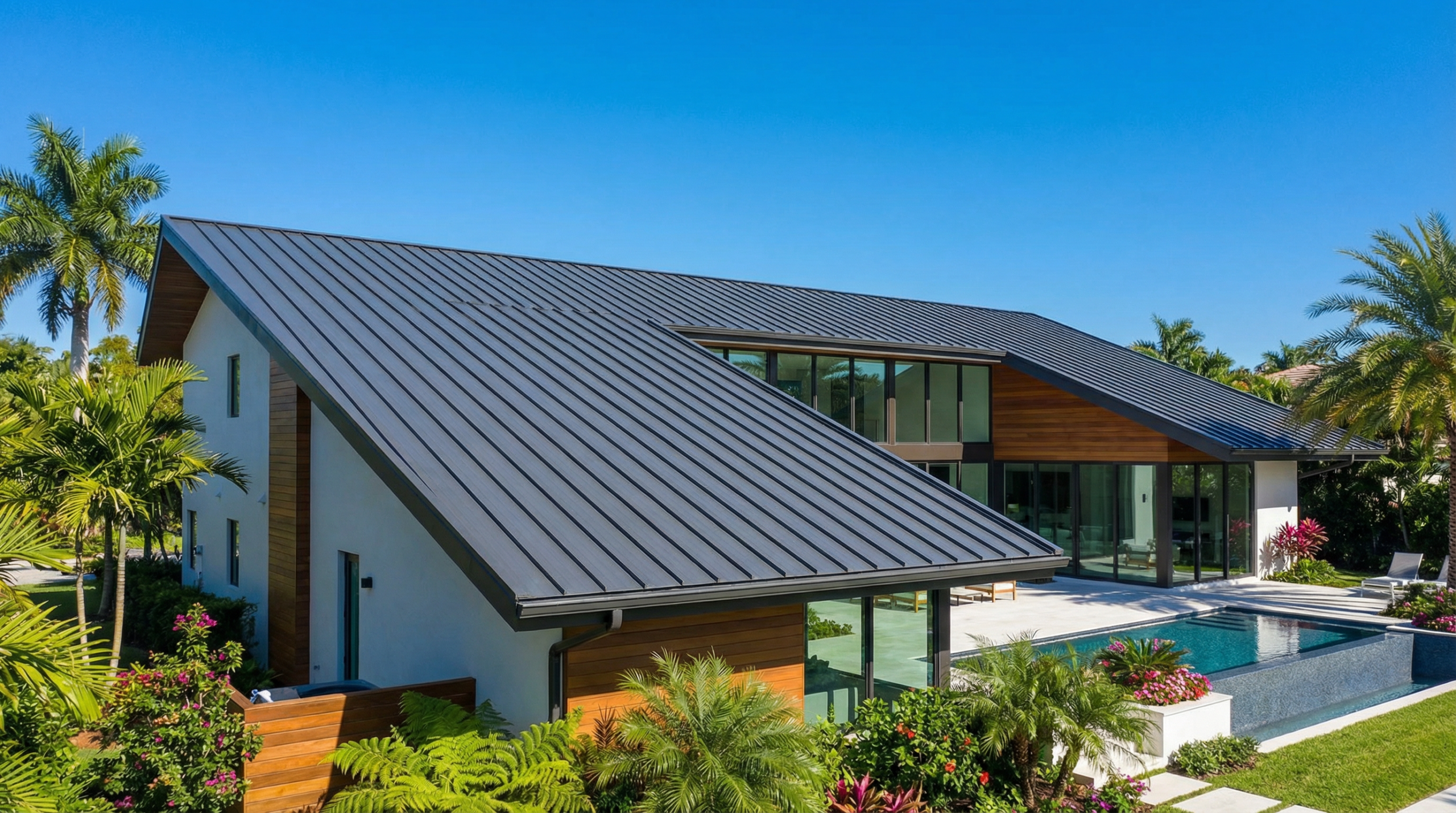 Modern Boca Raton home with a dark gray standing seam metal roof
