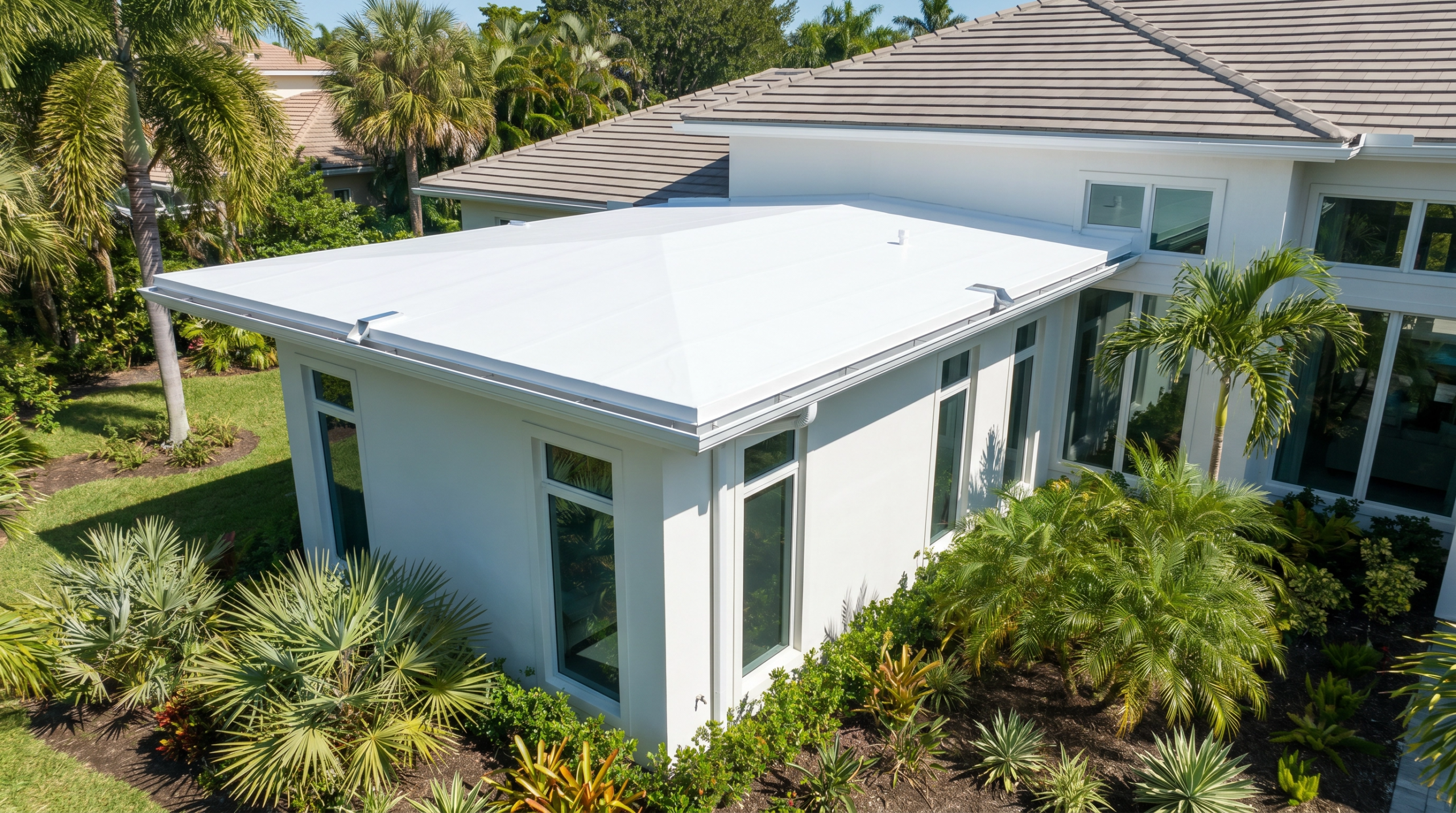 Professional white TPO flat roof installation on a North Palm Beach residential addition.