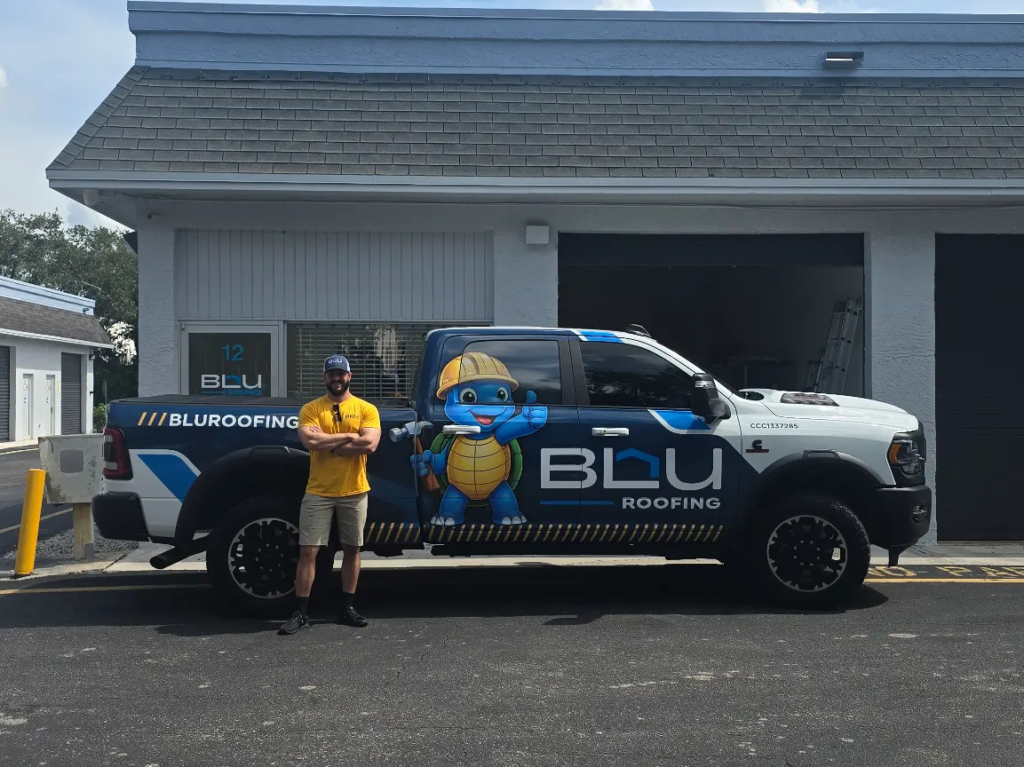 Peter Menke, owner of BLU Roofing, with branded truck at local office